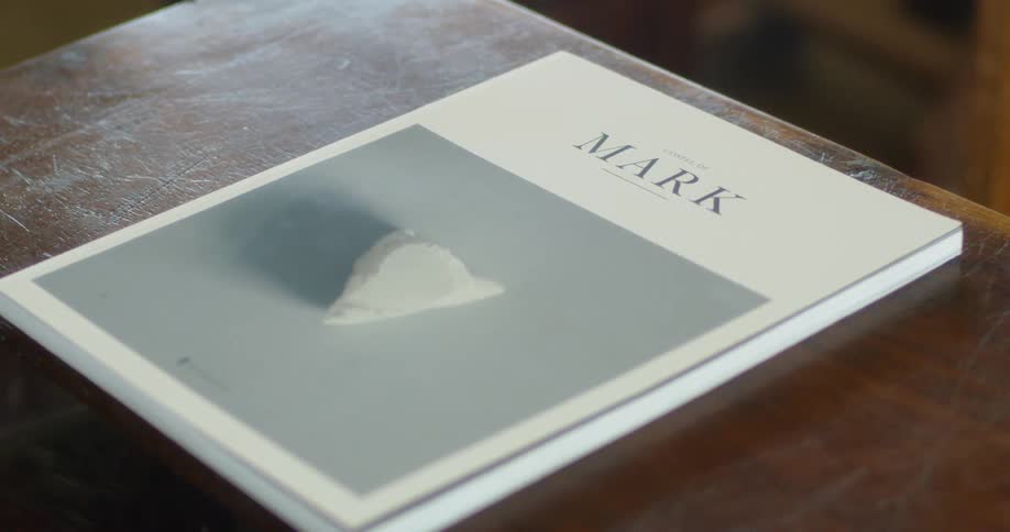 A book sits on a desk