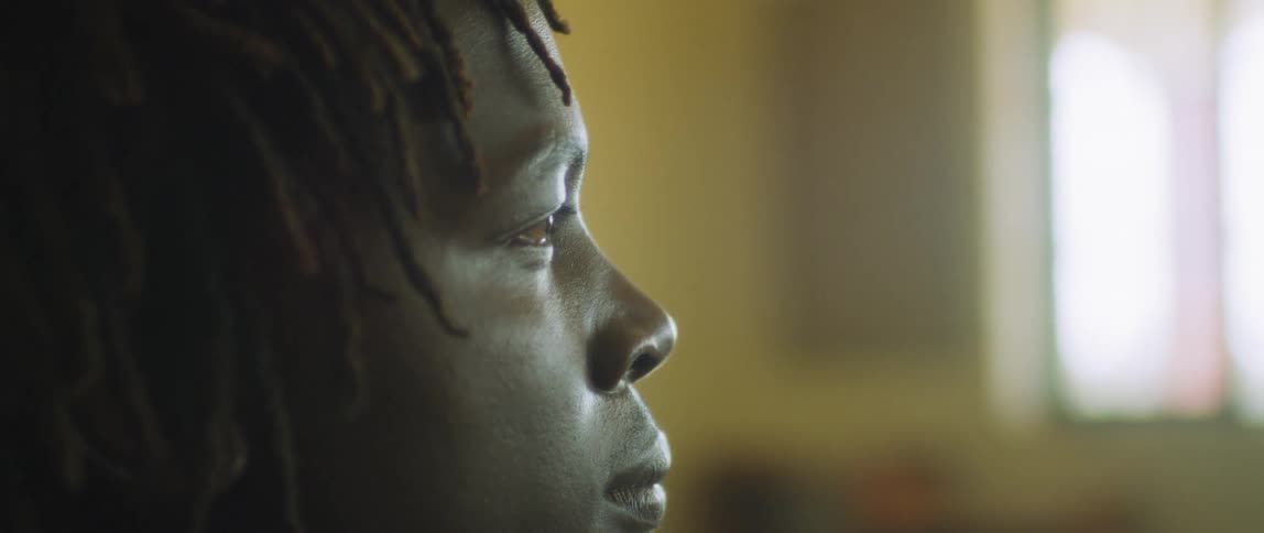Sunlight coming through a window shines on a person's face