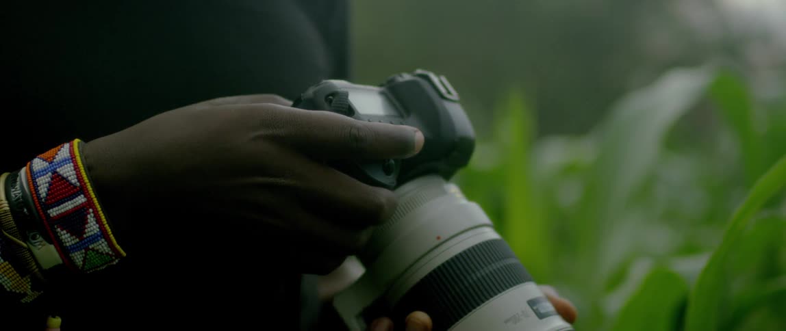 A make adjusts settings on a camera