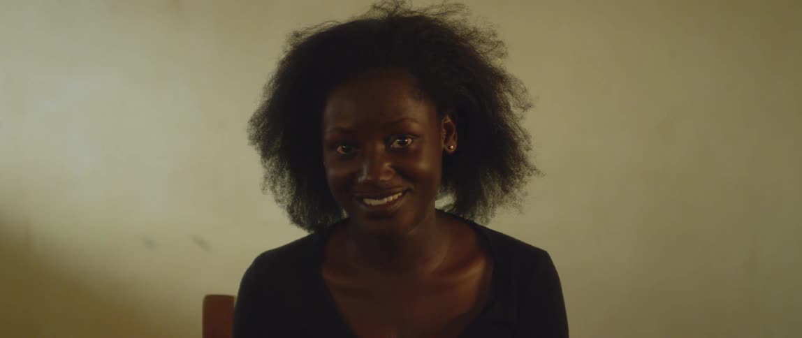 Woman sits and smiles