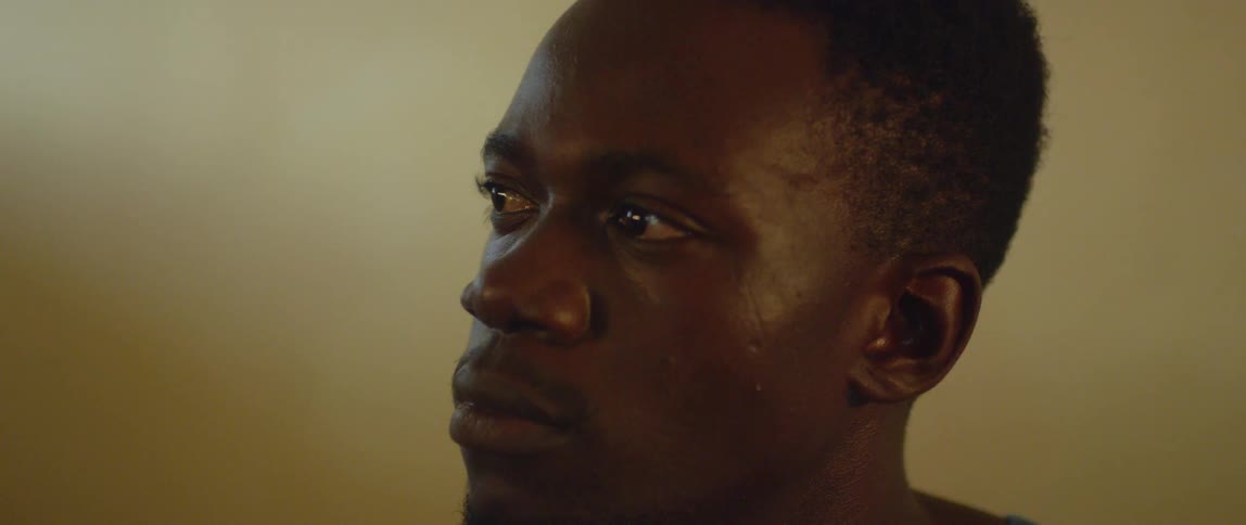 A man stares to his side and blinks