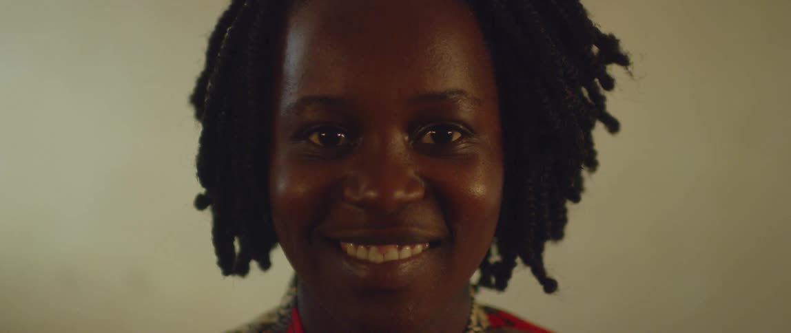 A woman blinks and smiles