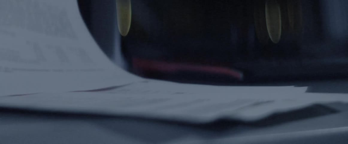 Papers fall onto a desk