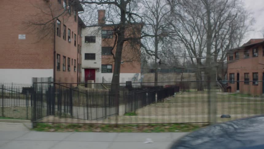 The neighborhood has buildings lined with fences