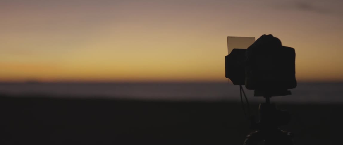 A camera rests at the ocean