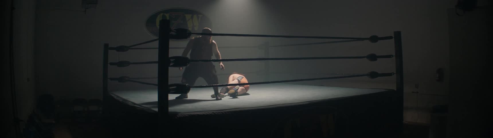 Two men wrestle in a wrestling ring