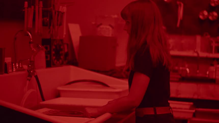 A woman is developing a picture in a photography lab