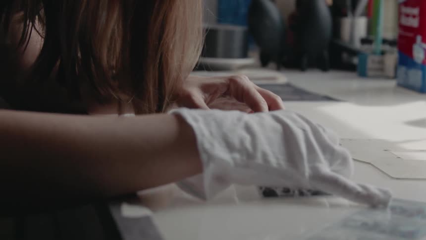 A photographer examines photo negatives