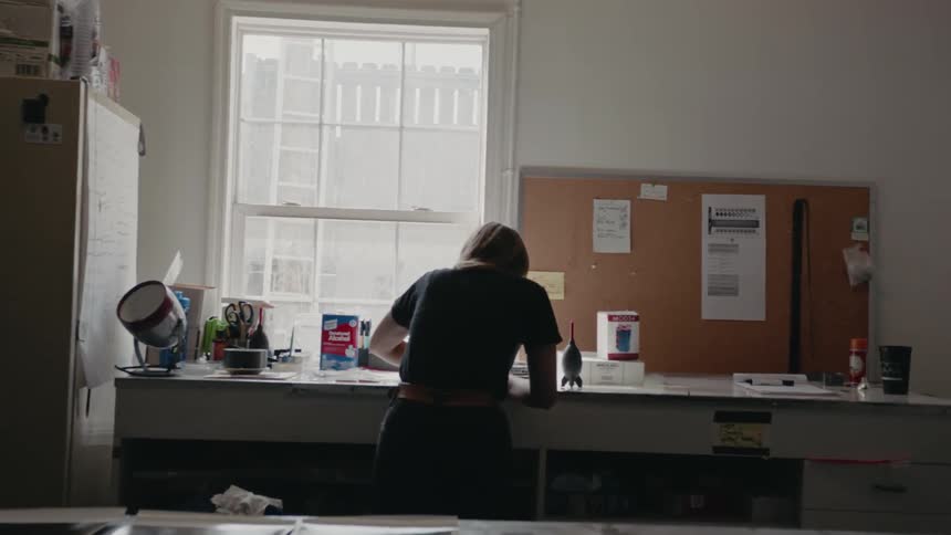 A person is working near the desk