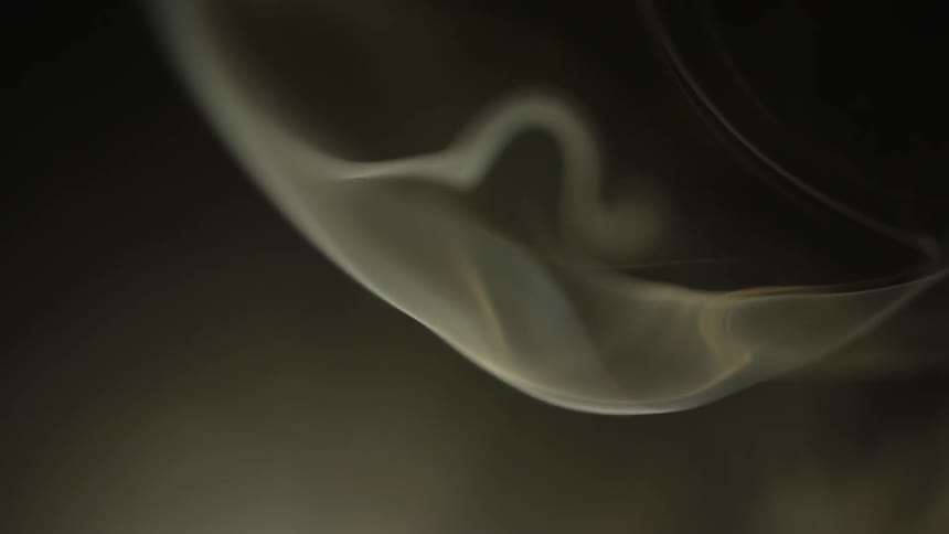 The smoke slowly swirls in the air