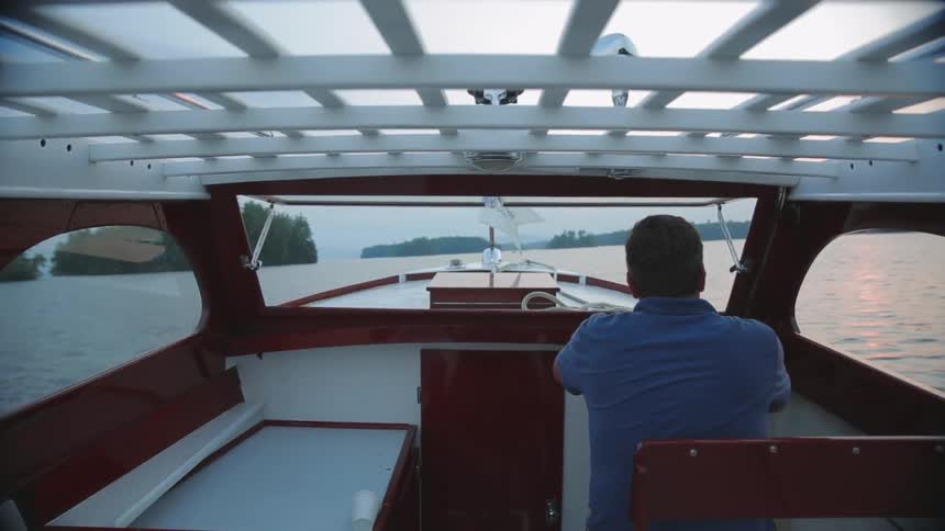 A man steers a boat