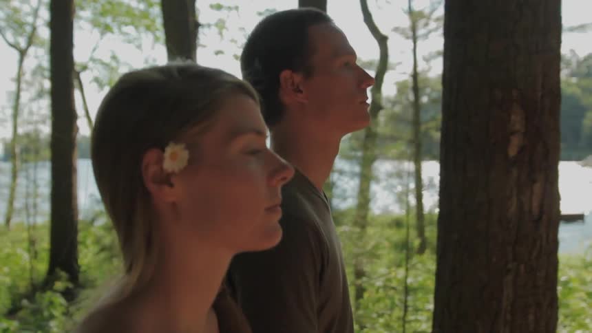 A man and woman walk in the woods