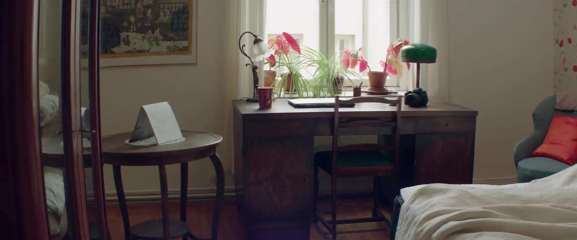 A old wooden desk is sitting in front of a window