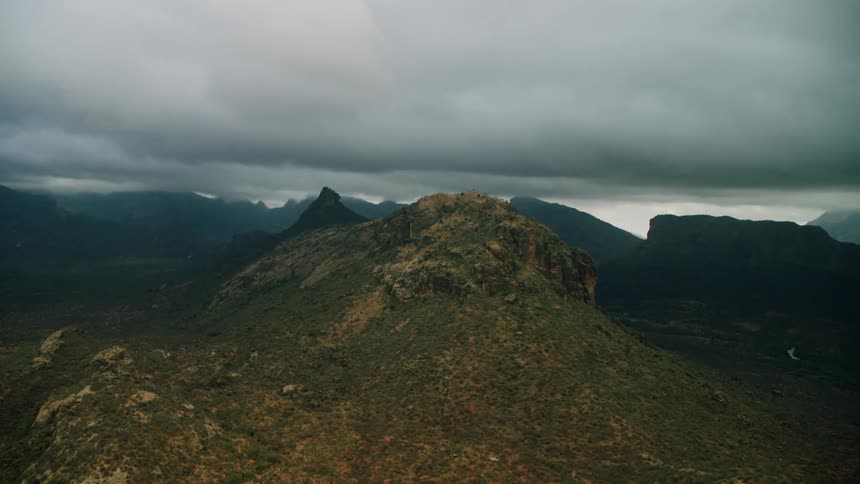Compressed clouds hover over mountain range