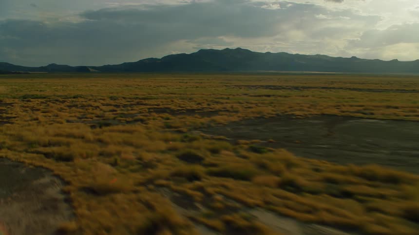 Grassy flat lands with clouds overhead