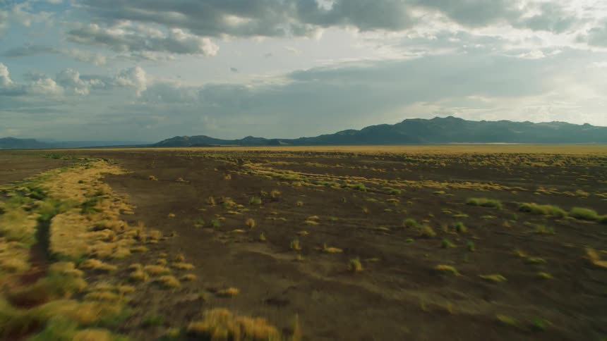 A large field with hills in the background