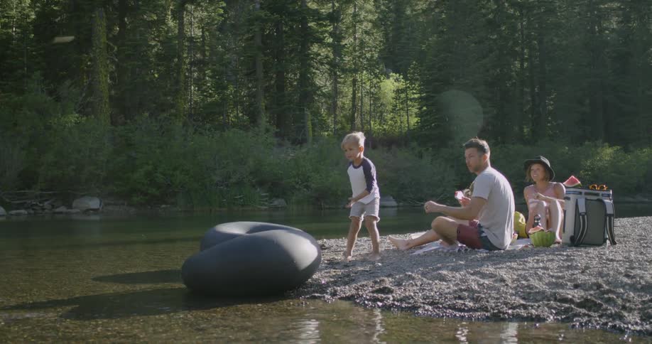A family are enjoying a summer day in a natural setting