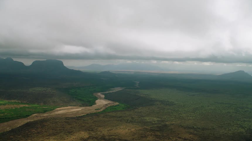 Thick clouds covering flat land and mountain wilderness