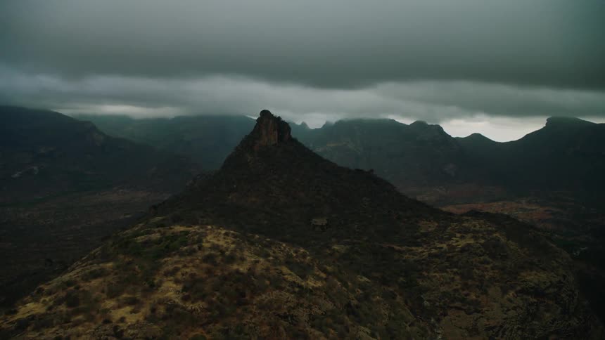 Storm clouds float above mountains