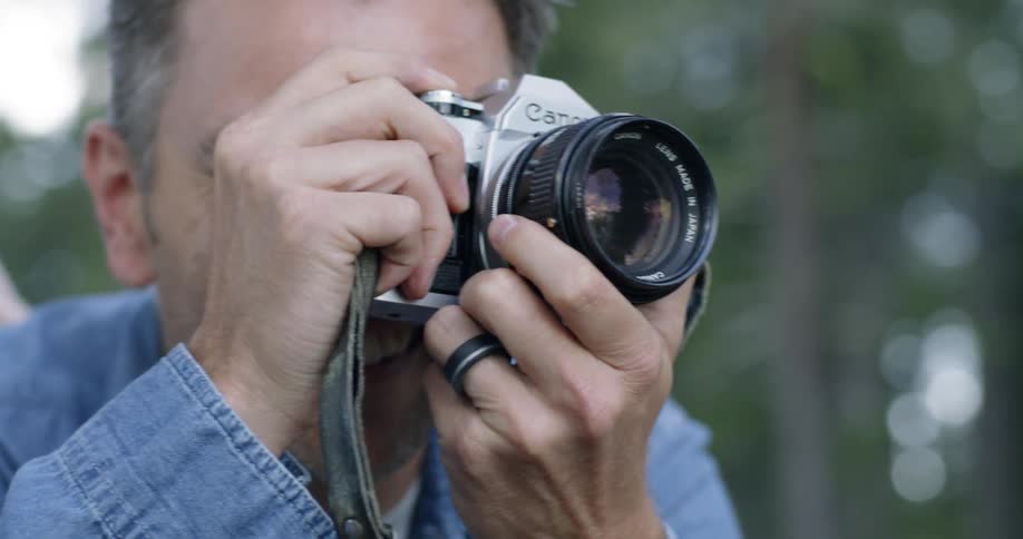 Man takes picture of nature with a large camera