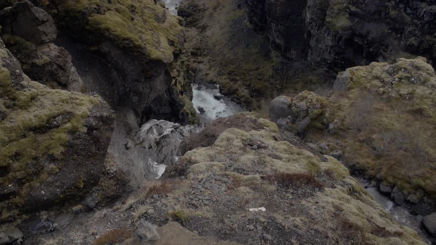 Water falls down a stone cliff