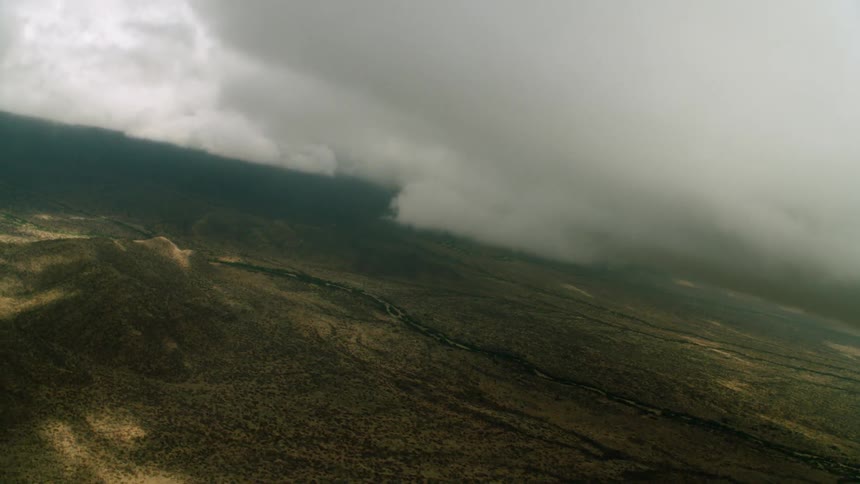 Flying above a valley with low clouds