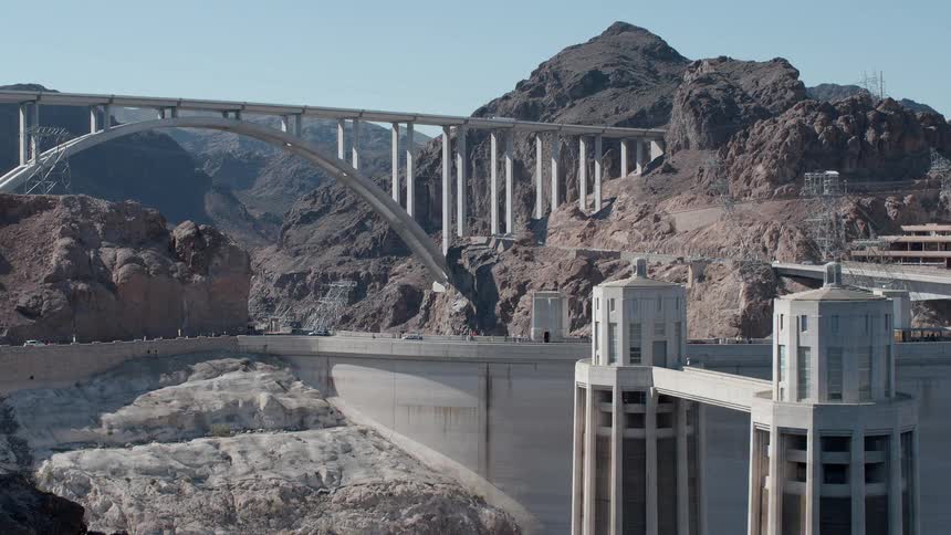 Cars travel across a dam