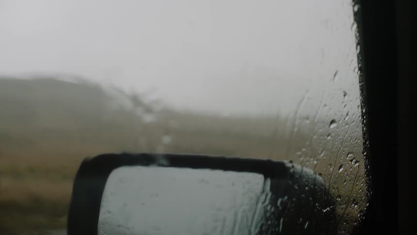 Rain is falling on a car window