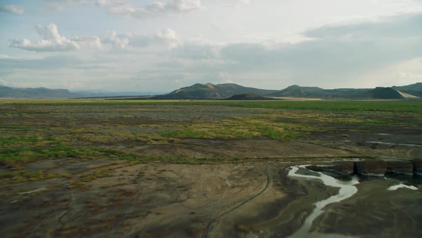 Vast flat lands and mountains on cloudy day