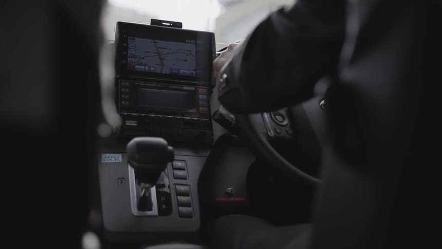 A person is using a navigation system as they drive