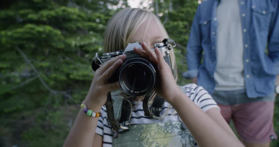 Child takes a picture with a large camera