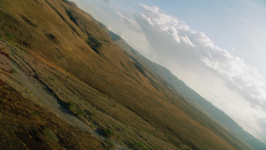 Hilly landscape with clouds overhead