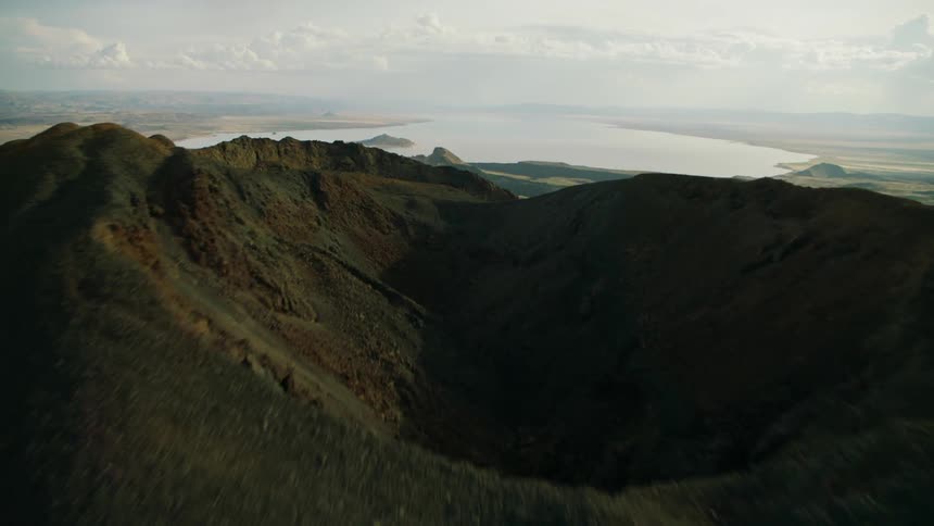 Mountains and valleys next to the sea on a cloudy day