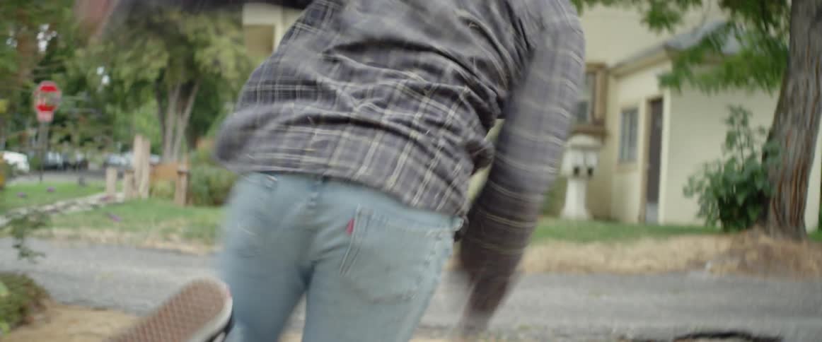 Man tumbles on the ground then gets up and runs through yard