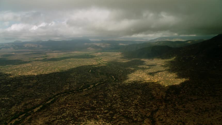 Thick clouds shadow over mountain valley
