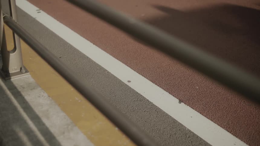A bicyclist passes on a road as vehicles drive