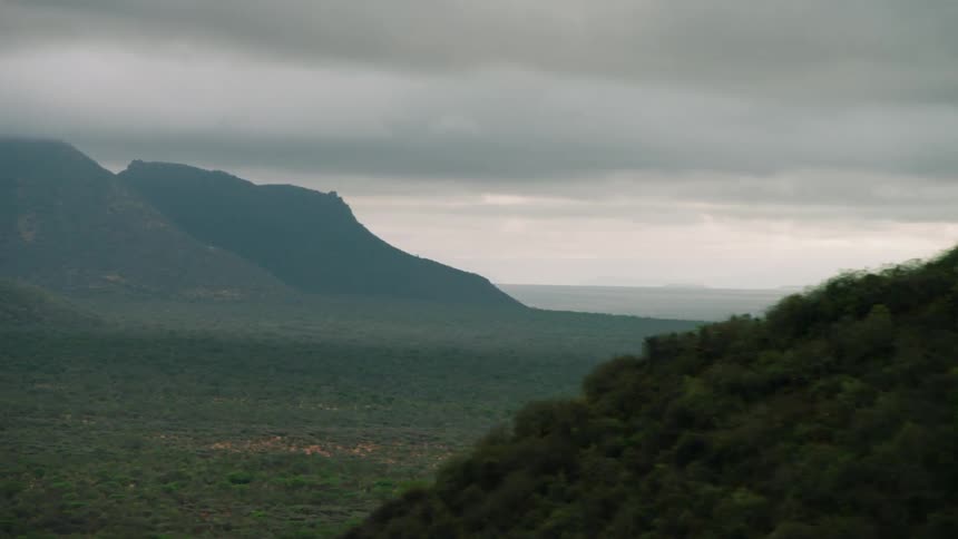 Clouds hover low over the hills and plains
