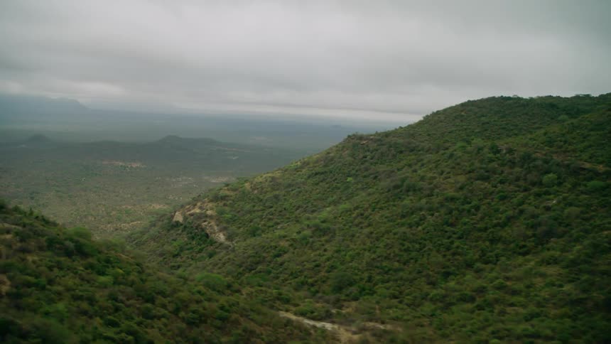Tree covered mountains with clouds overhead