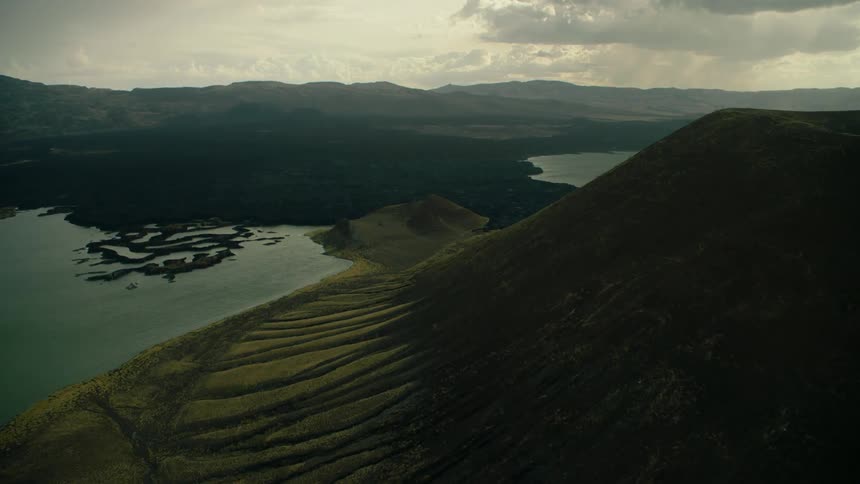 Bodies of water in and near mountains on a cloudy day