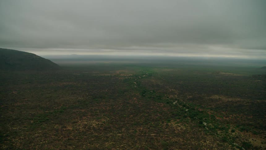 Storm clouds hanging over a river and desert landscape in daylight