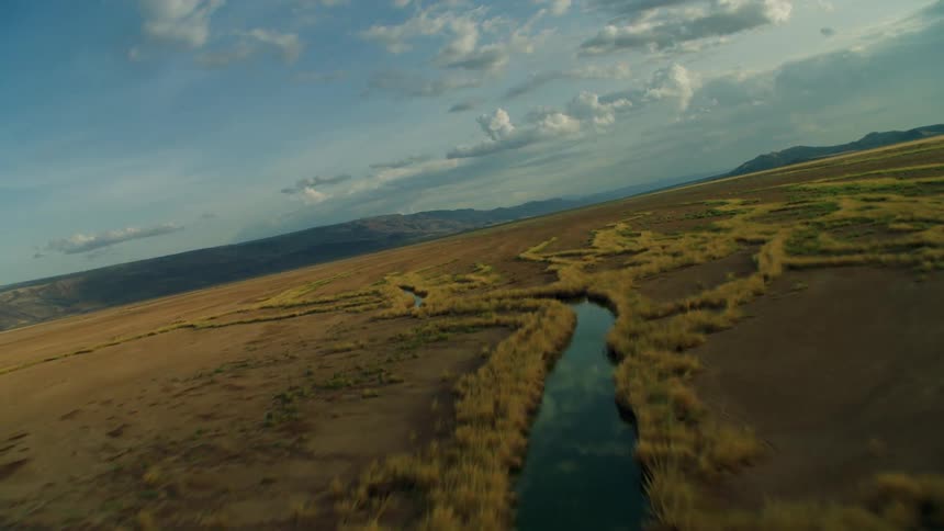 Stream winds through flat plains