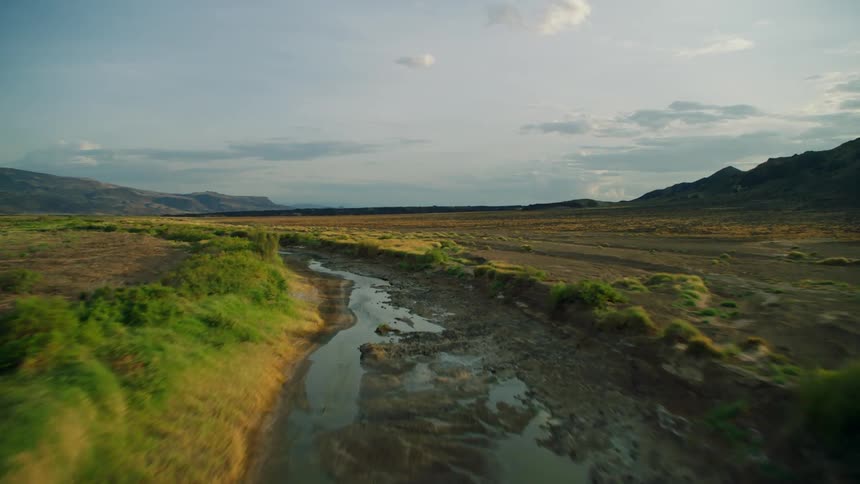 Canal cutting through a mountain valley