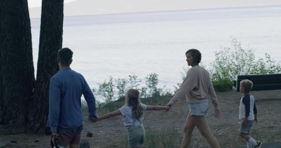A family walk over to the lake