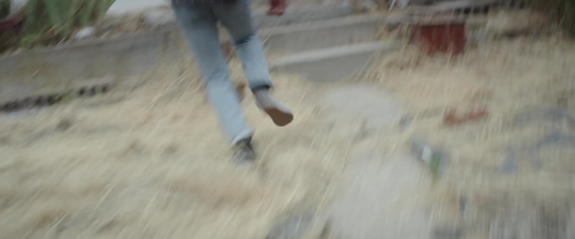 A man flees through a houses front yard