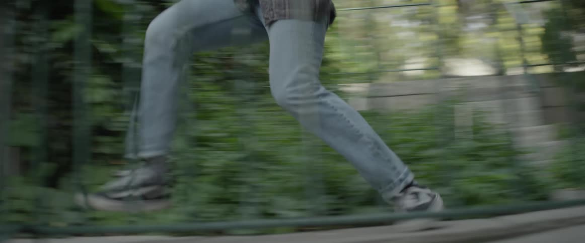A man runs through a yard and down some steps