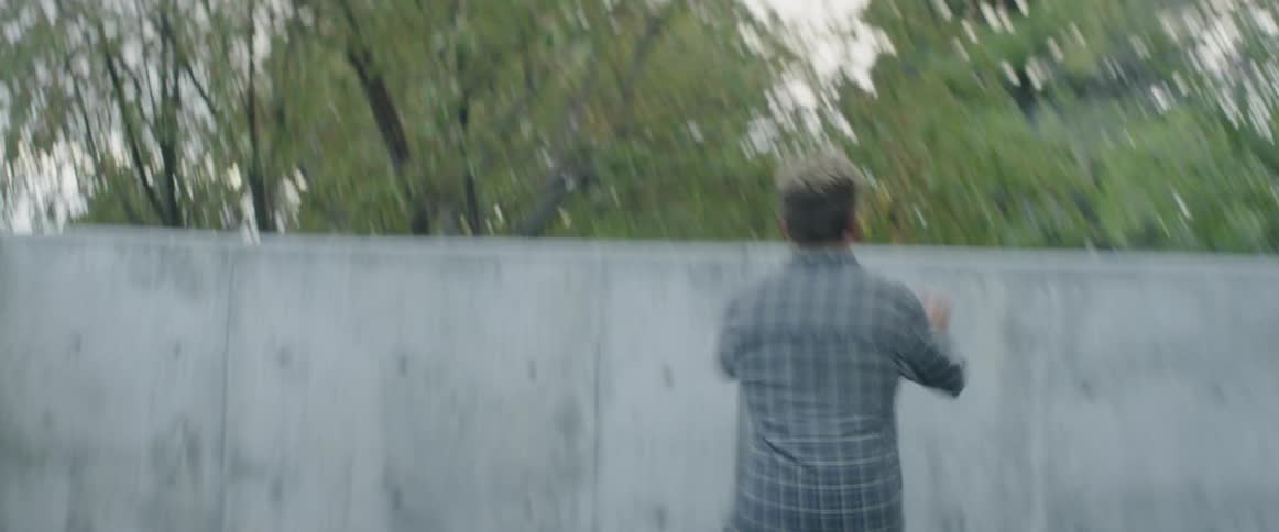 Man running and hopping over concrete wall
