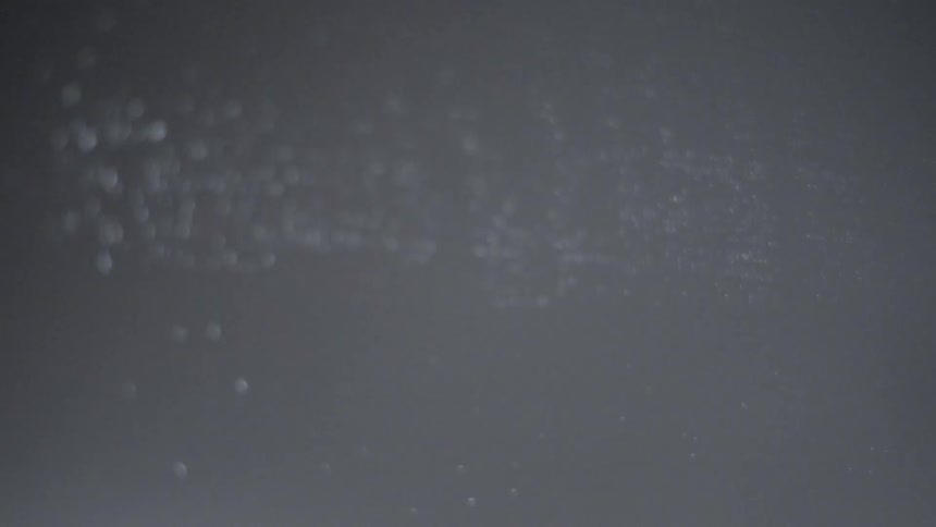 Bubbles sticking to a surface in light