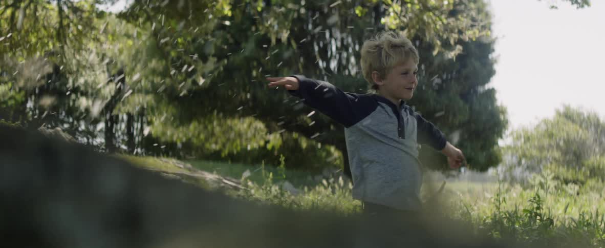 A young boy plays outside