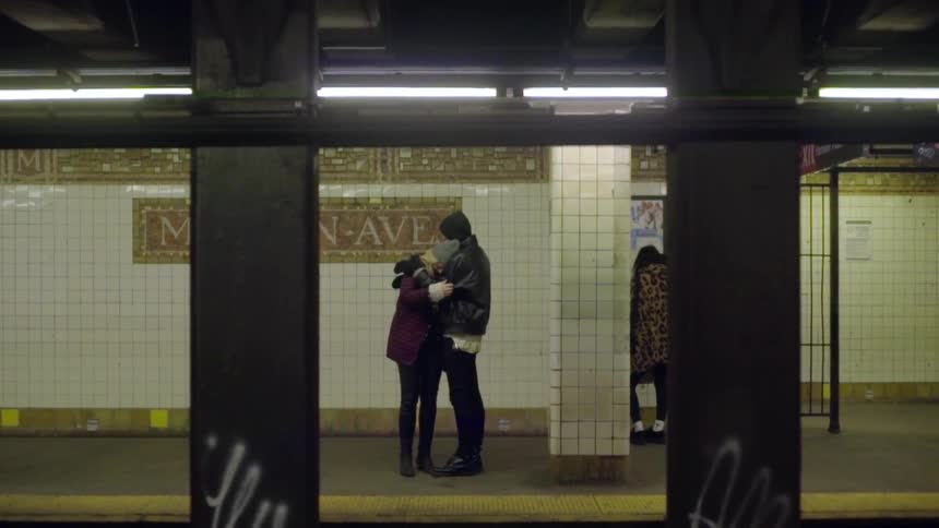 Two people hugging at the subway station
