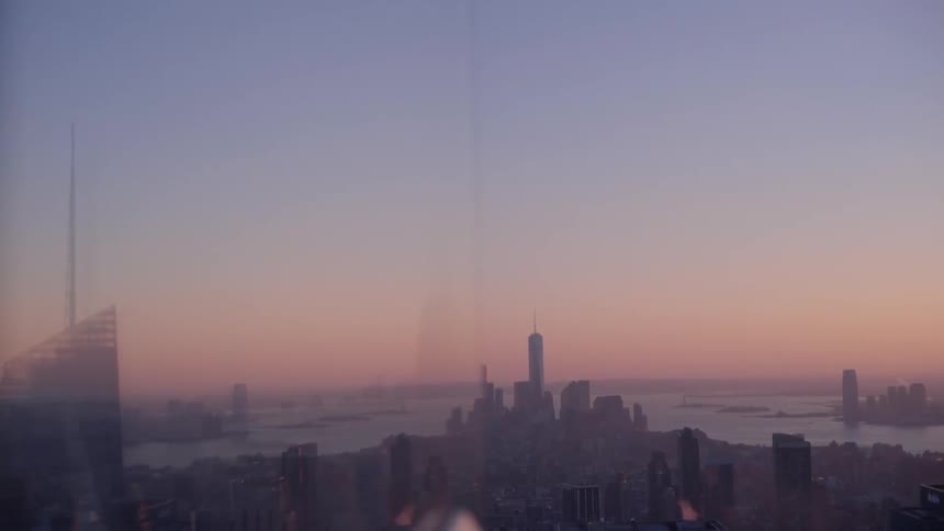 A city is shown at sunset